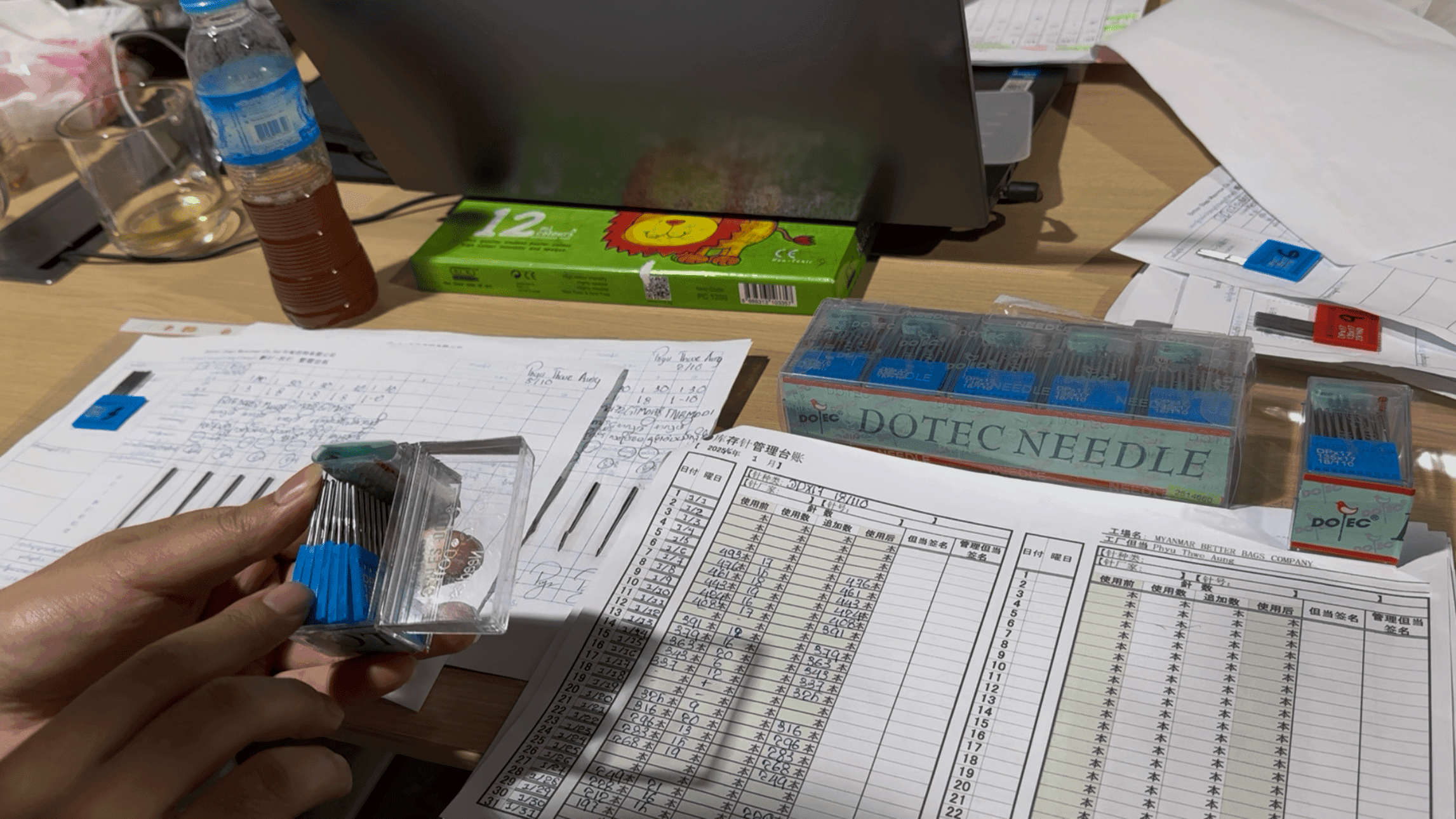 Hand-written records in the needle-control ledger, plus a box of DOTEC NEEDLE